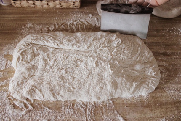 Dough in rectangle form on floured surface