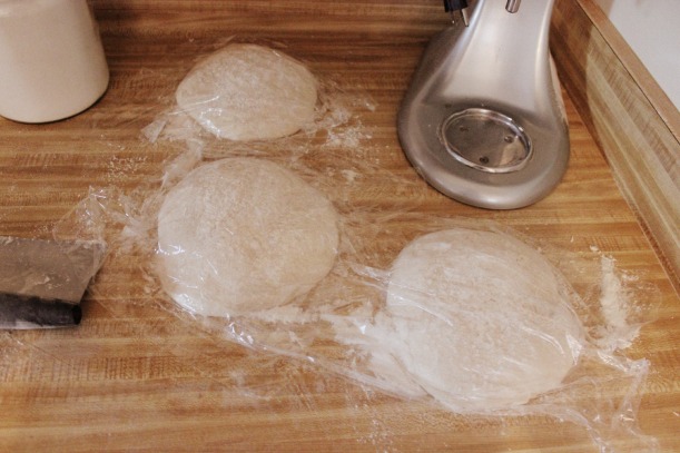Cover each dough ball with oiled saran wrap and let sit again